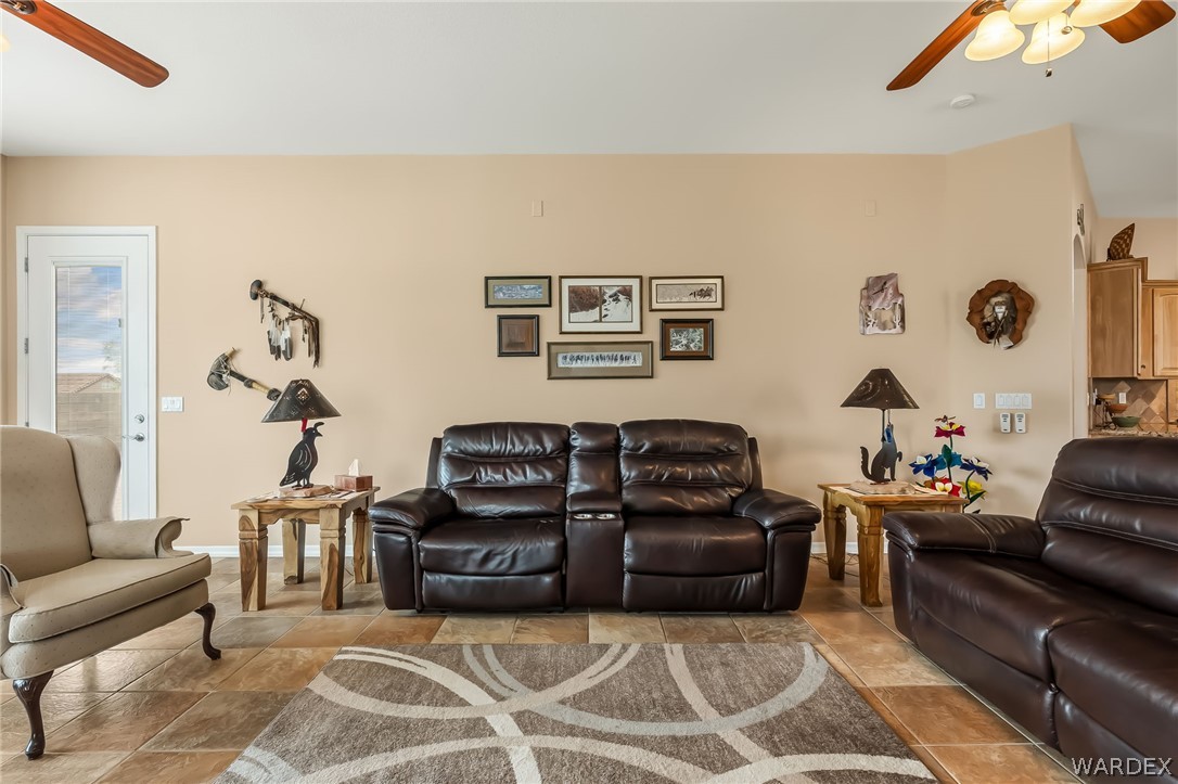 2708 Discovery Road Bullhead City, AZ 86442 - Photo 37 of 90 Living room featuring neutral-toned walls, tile flooring, and a glass-paneled door