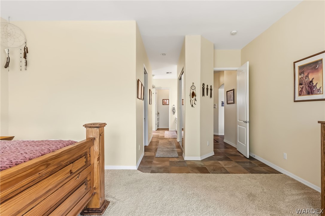 2708 Discovery Road Bullhead City, AZ 86442 - Photo 44 of 90 This bedroom features a light beige carpet and a wooden bed frame