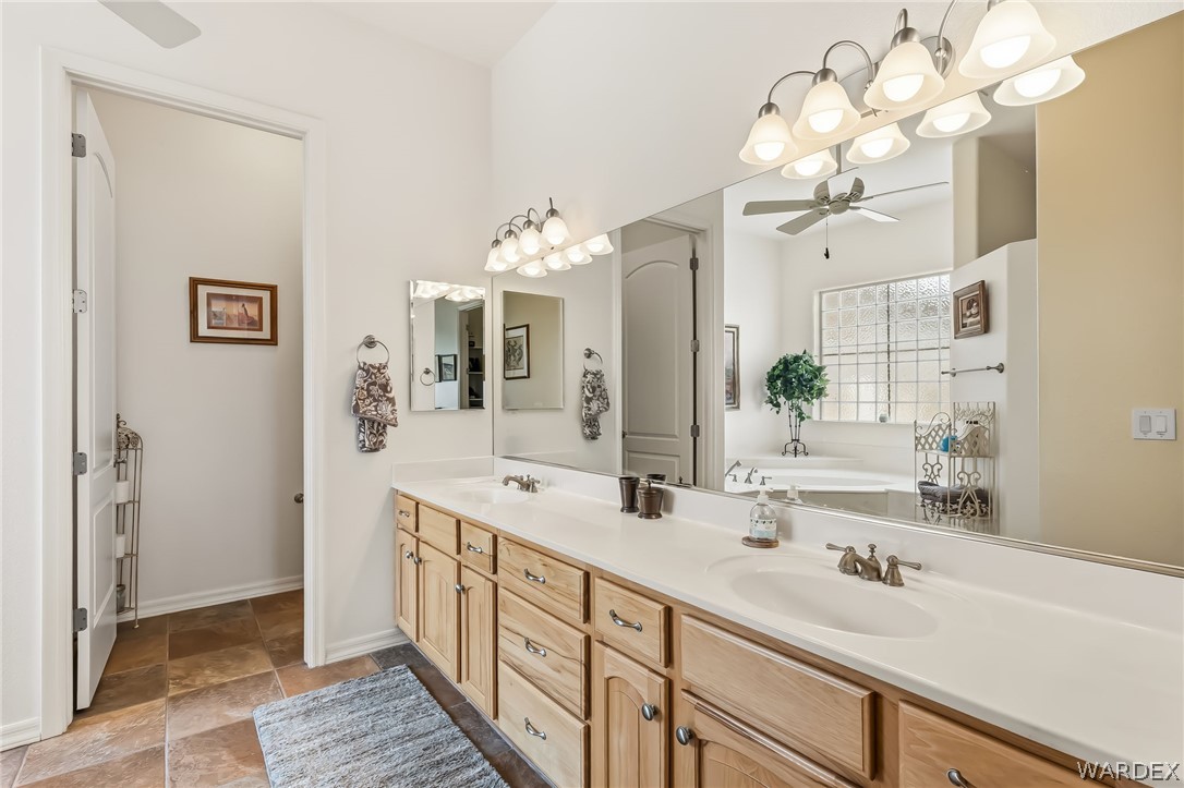2708 Discovery Road Bullhead City, AZ 86442 - Photo 49 of 90 A spacious bathroom featuring a double vanity with light wood cabinetry, a large mirror, and tiled flooring