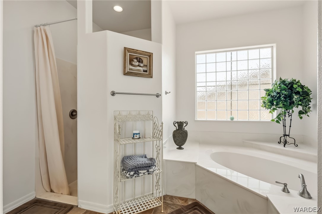 2708 Discovery Road Bullhead City, AZ 86442 - Photo 50 of 90 a bathroom with a tub a sink and a window