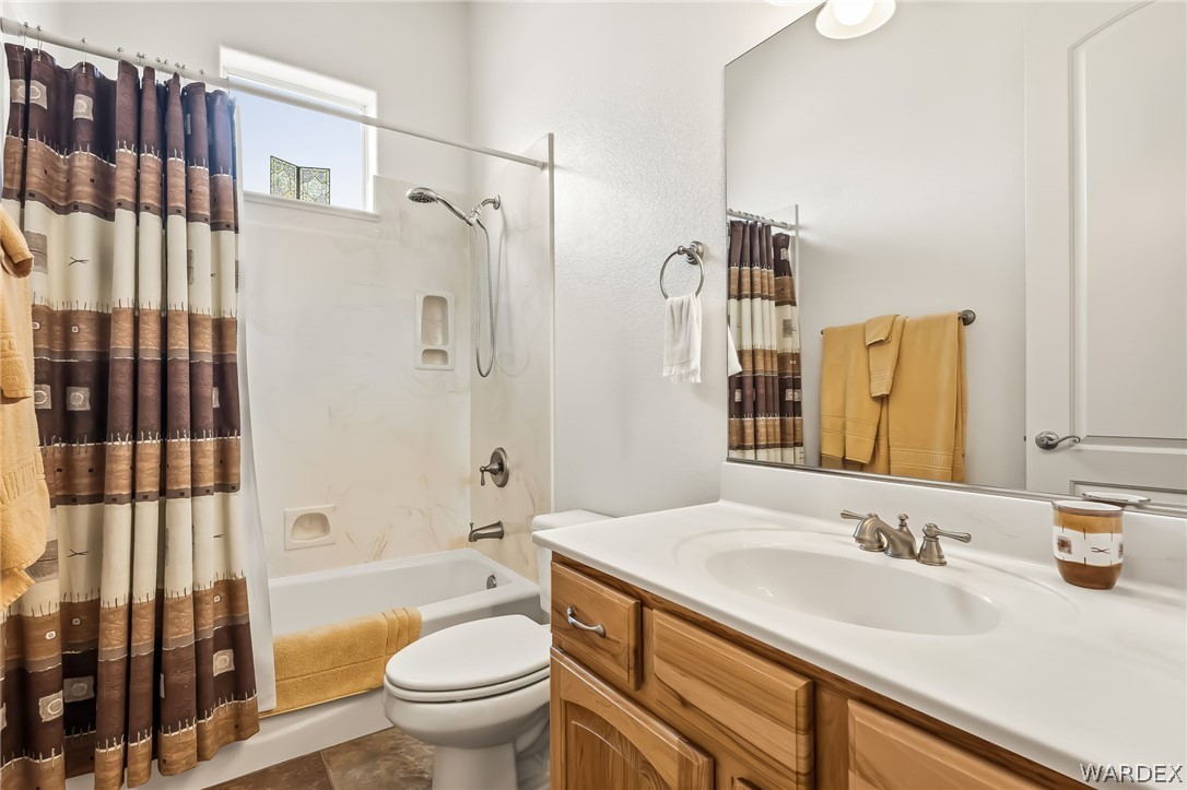 2708 Discovery Road Bullhead City, AZ 86442 - Photo 54 of 90 Bathroom featuring a vanity with a white countertop and wood cabinetry, a mirror, and a shower-tub combination