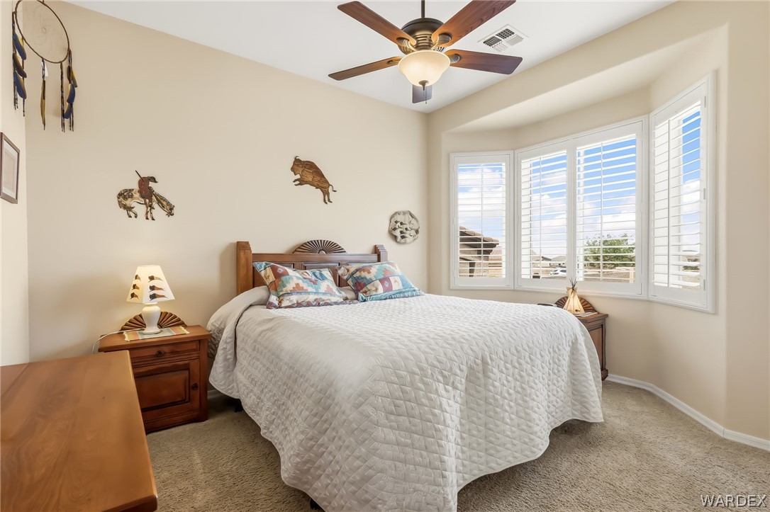 2708 Discovery Road Bullhead City, AZ 86442 - Photo 55 of 90 a bedroom with a bed and a chandelier