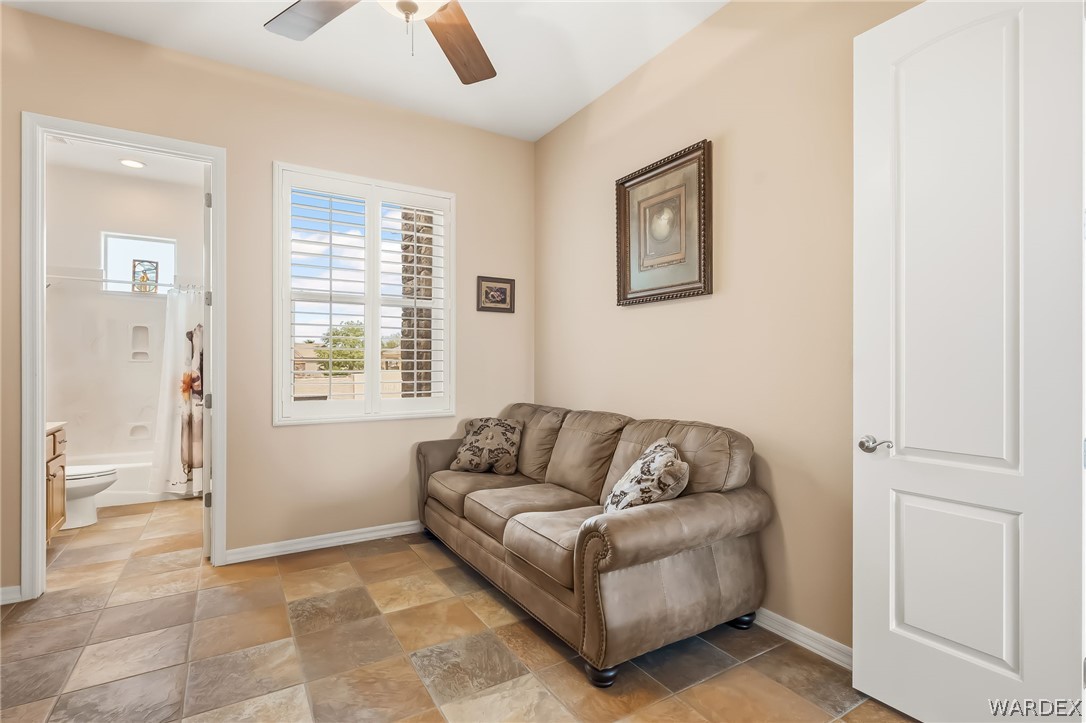 2708 Discovery Road Bullhead City, AZ 86442 - Photo 59 of 90 This room features tile flooring, a window with white shutters, and a ceiling fan