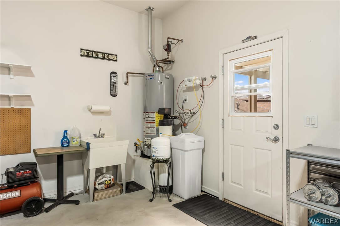 2708 Discovery Road Bullhead City, AZ 86442 - Photo 66 of 90 Utility room with a water heater, water softener system, and a utility sink