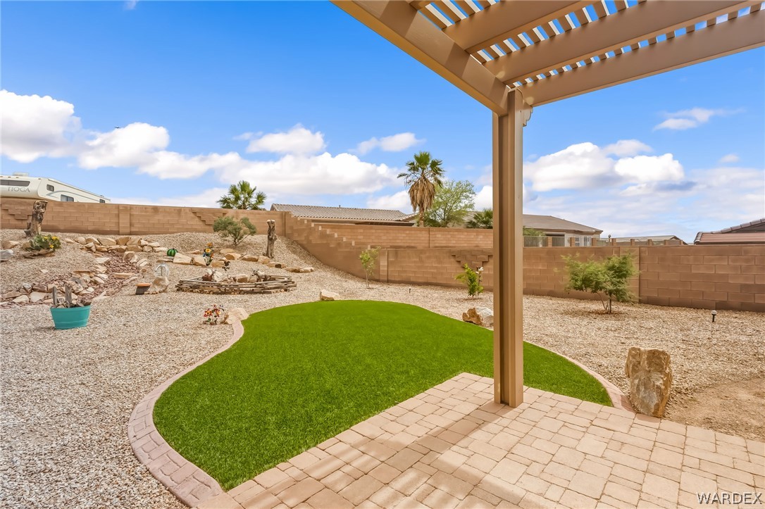 2708 Discovery Road Bullhead City, AZ 86442 - Photo 69 of 90 The property features a spacious backyard with a paver patio and an overhead pergola