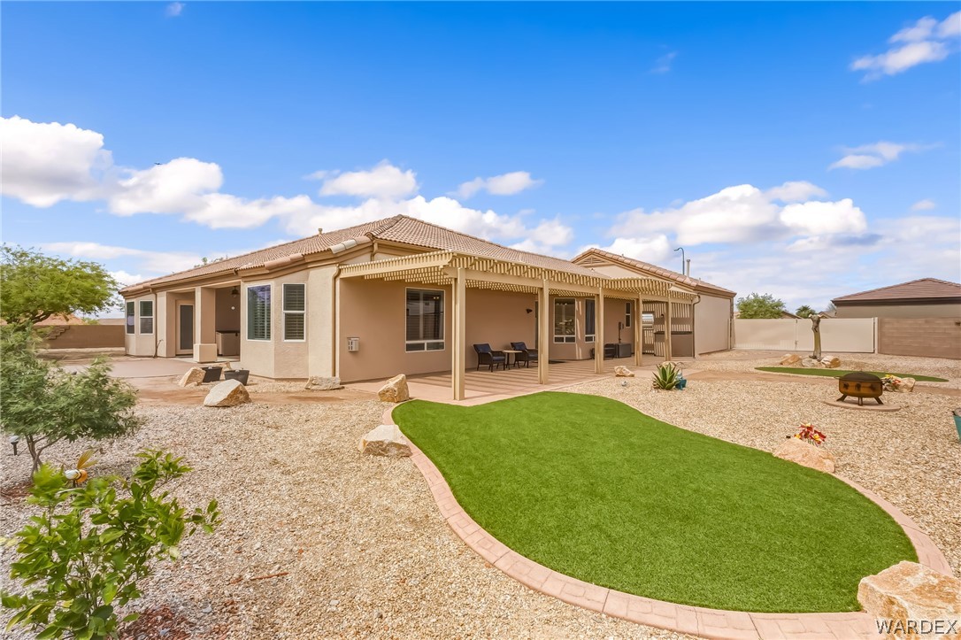 2708 Discovery Road Bullhead City, AZ 86442 - Photo 70 of 90 a view of a house with backyard sitting area and garden