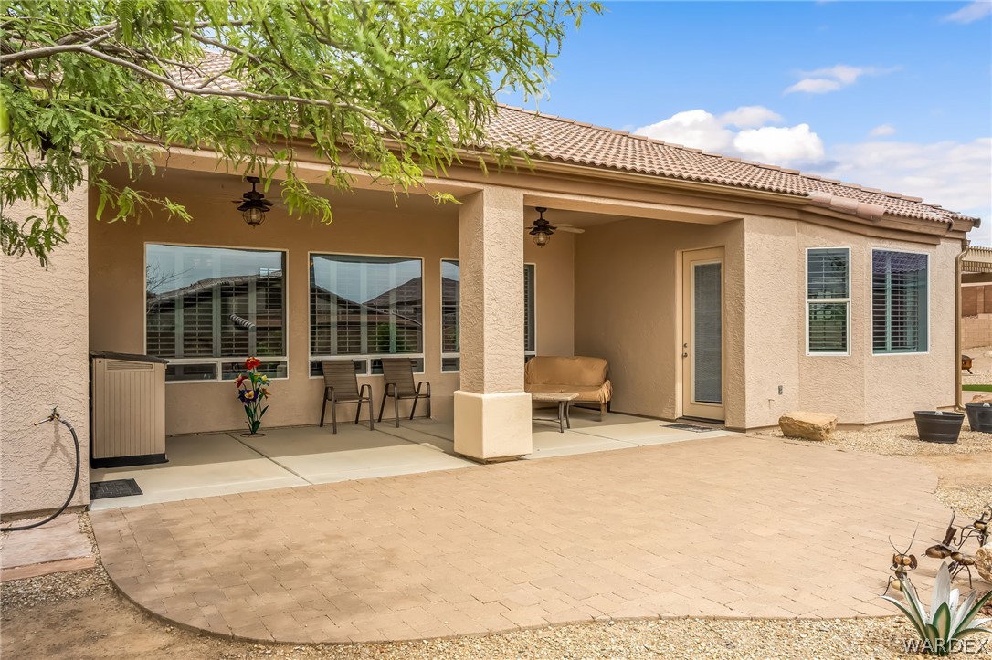 2708 Discovery Road Bullhead City, AZ 86442 - Photo 77 of 90 The property features an outdoor patio with a tiled roof, ceiling fans, and a combination of paved and gravel ground cover