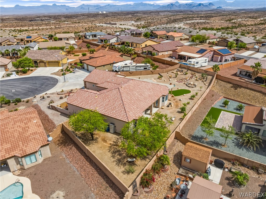2708 Discovery Road Bullhead City, AZ 86442 - Photo 81 of 90 This property features a single-story residence with a tile roof, a desert-landscaped yard, and a paved driveway
