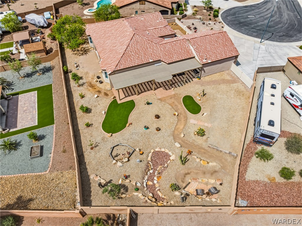 2708 Discovery Road Bullhead City, AZ 86442 - Photo 87 of 90 The property features a terraced backyard with a patio, a covered outdoor living area, and a putting green