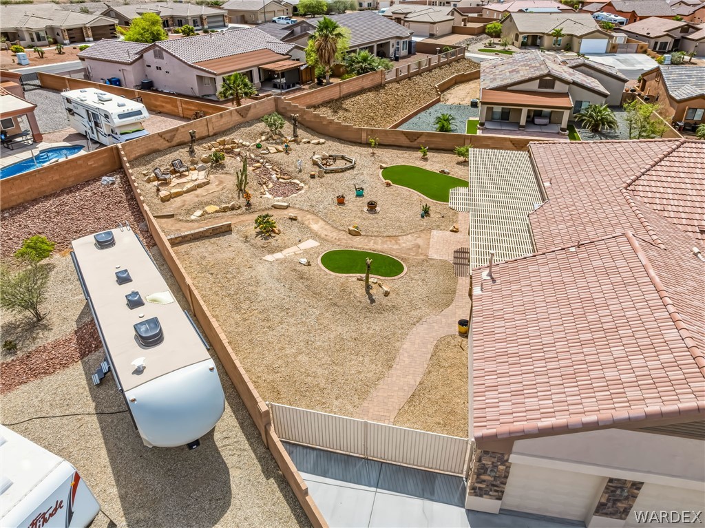 2708 Discovery Road Bullhead City, AZ 86442 - Photo 88 of 90 The property features an extensive backyard with desert landscaping, a winding pathway, and two distinct artificial turf areas