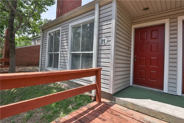 a view of empty room with wooden floor and fireplace
