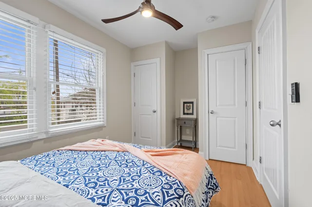a view of an empty room with wooden floor and closet