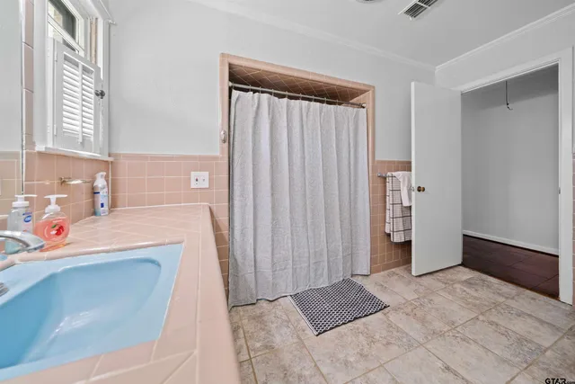a view of a bathroom with a sink and a washer dryer