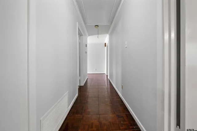 a view of a hallway with wooden floor