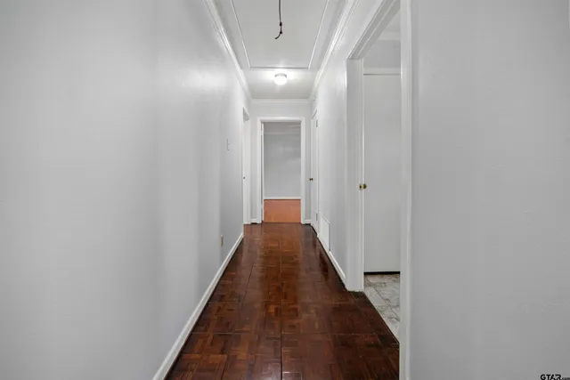 a view of a hallway with wooden floor