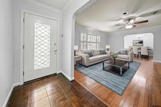 a living room with furniture and wooden floor