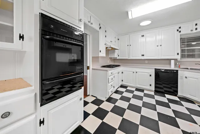 a kitchen with stainless steel appliances and cabinets