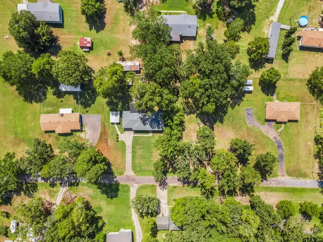 an aerial view of residential houses with outdoor space and street view