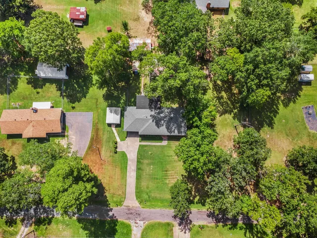 an aerial view of a house with a yard basket ball court and outdoor seating