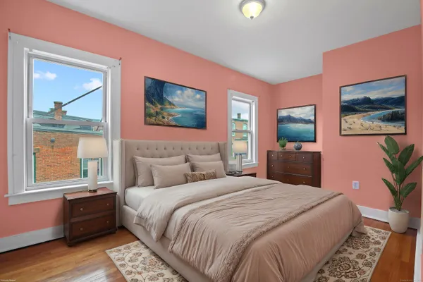 a bedroom with a bed and a painting on the wall