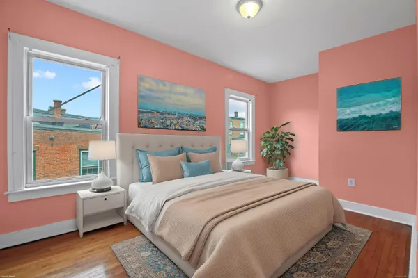 a bedroom with a bed and a painting on the wall