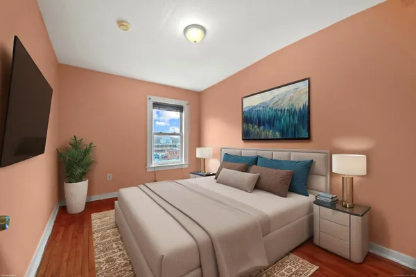 a bedroom with a bed and a flat screen tv