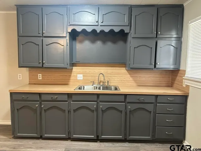 a bathroom with a sink and cabinets