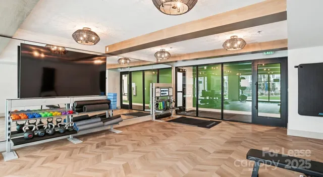 a room with lots of flat screen tv and a large window