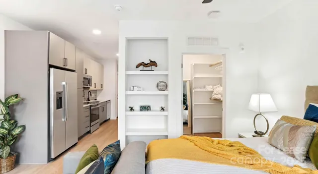 a spacious bedroom with a bed and a cabinets