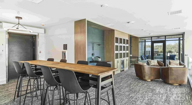 a living room with a table and chairs