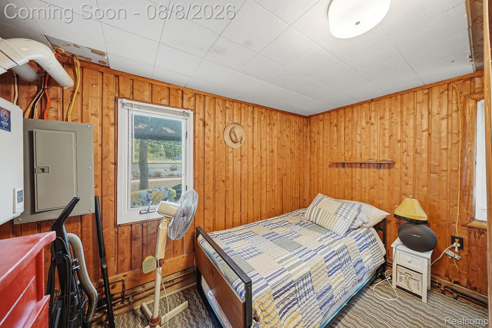 4599 Port Austin Road Caseville, MI 48725 - Photo 21 of 40 Wood-paneled walls with a dropped ceiling and exposed conduit