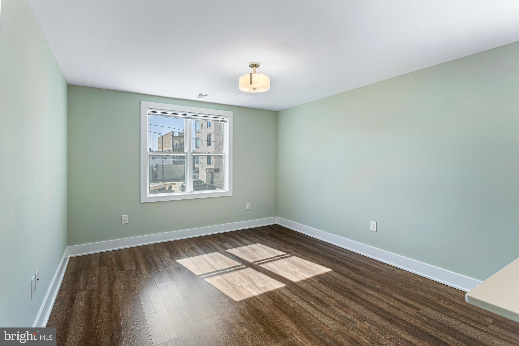 1219 K Street Northeast, Unit 209 Washington, DC 20002 - Photo 5 of 12 wooden floor in an empty room with a window