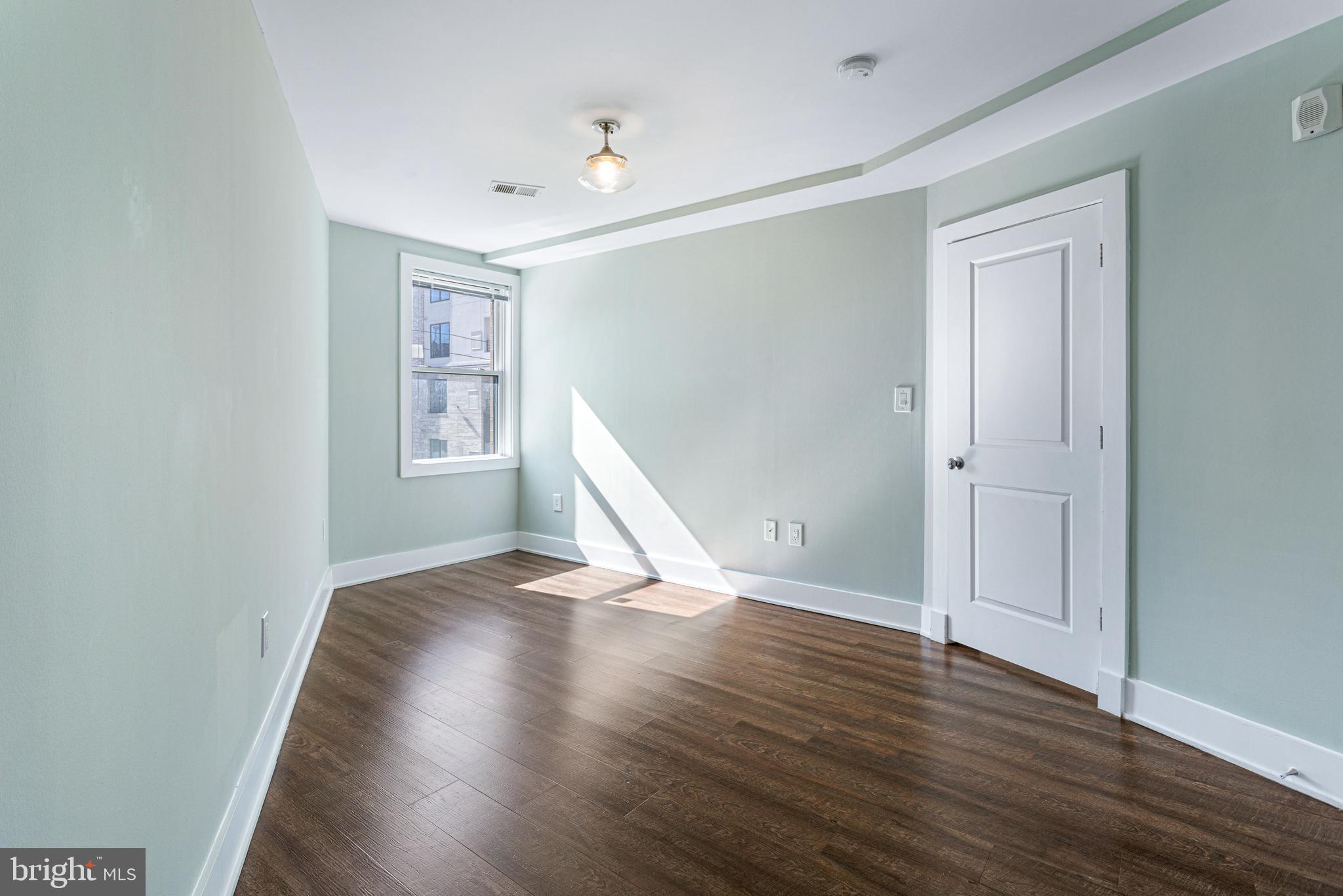 1219 K Street Northeast, Unit 209 Washington, DC 20002 - Photo 7 of 12 a view of empty room with wooden floor and fan