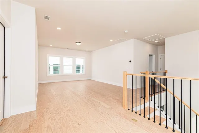 a view of an empty room with wooden floor