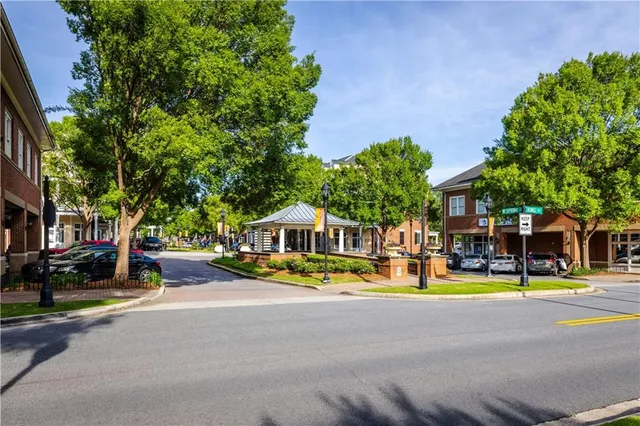 a front view of a house with a yard and tree s