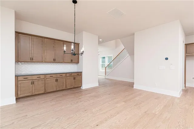 a view of a kitchen with wooden floor and electronic appliances