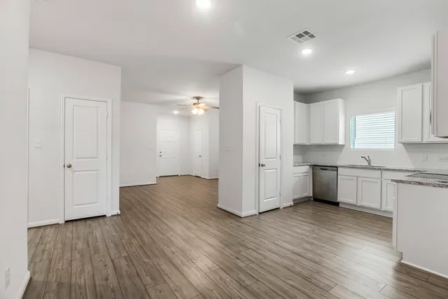 a view of kitchen with wooden floor electronic appliances and window