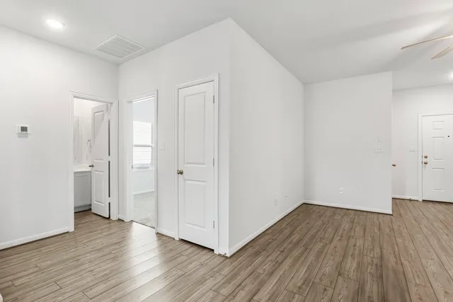 a view of a room with wooden floor