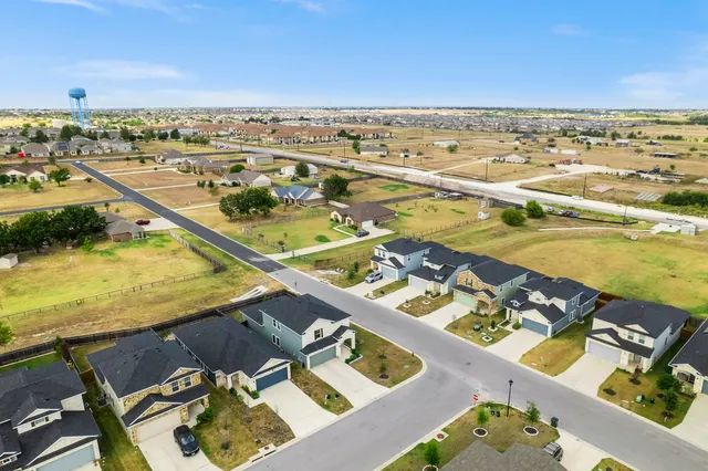 an aerial view of a house with swimming pool and ocean view