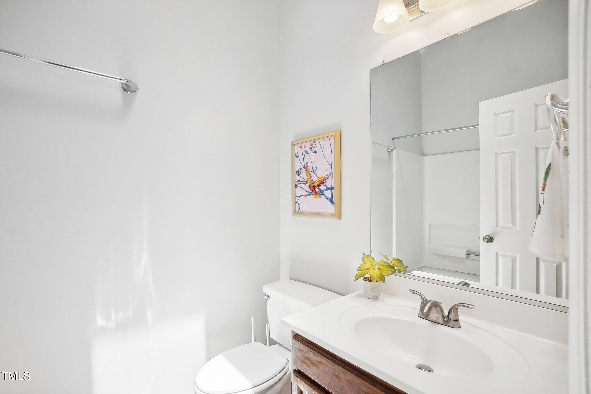 902 Gatehouse Lane Durham, NC 27707 - Photo 13 of 17 a bathroom with a sink toilet and a mirror