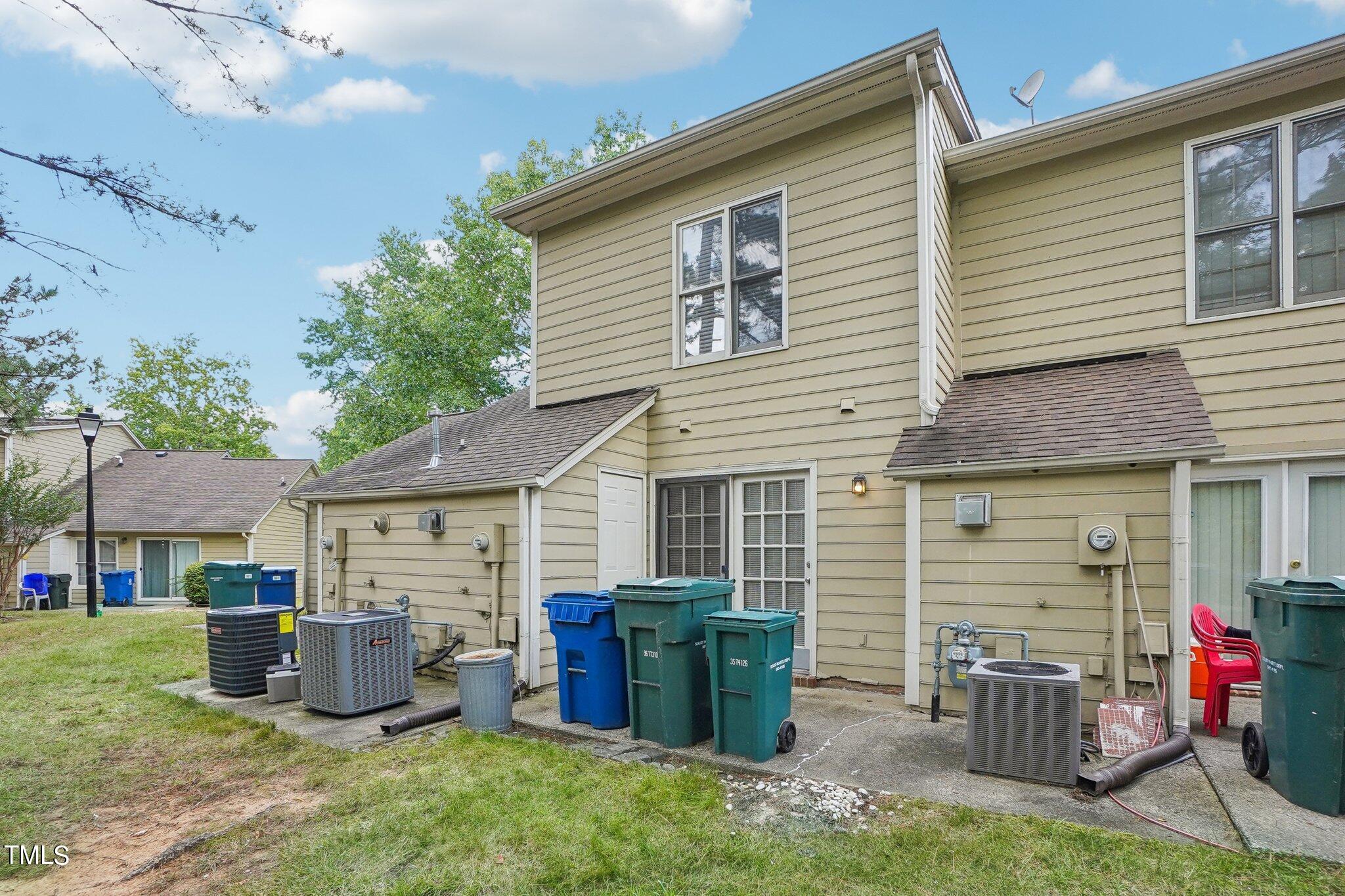 902 Gatehouse Lane Durham, NC 27707 - Photo 17 of 17 a view of a backyard with furniture and a garage