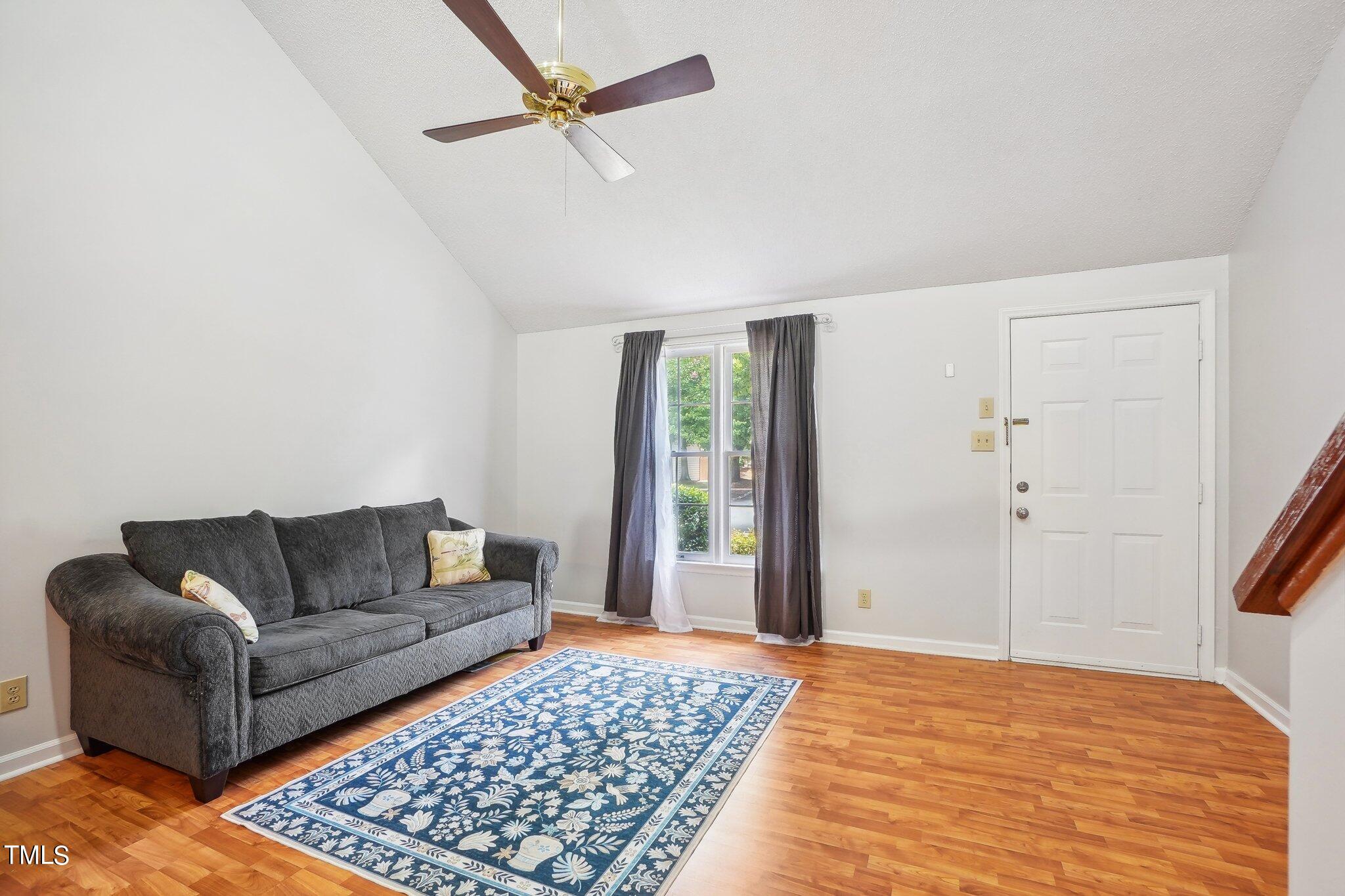 902 Gatehouse Lane Durham, NC 27707 - Photo 4 of 17 a living room with furniture and a rug