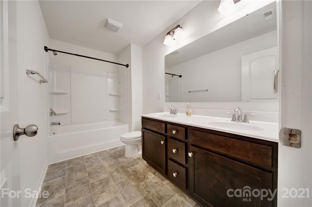 3097 Riker Street Clover, SC 29710 - Photo 33 of 39 a bathroom with a sink double vanity granite tub shower and a mirror