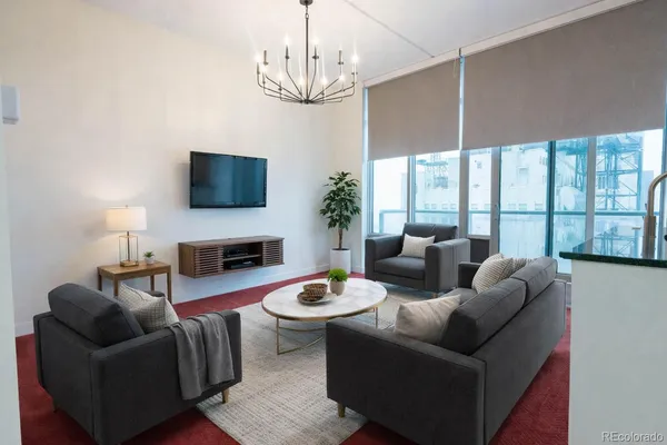 a living room with fireplace furniture and a flat screen tv