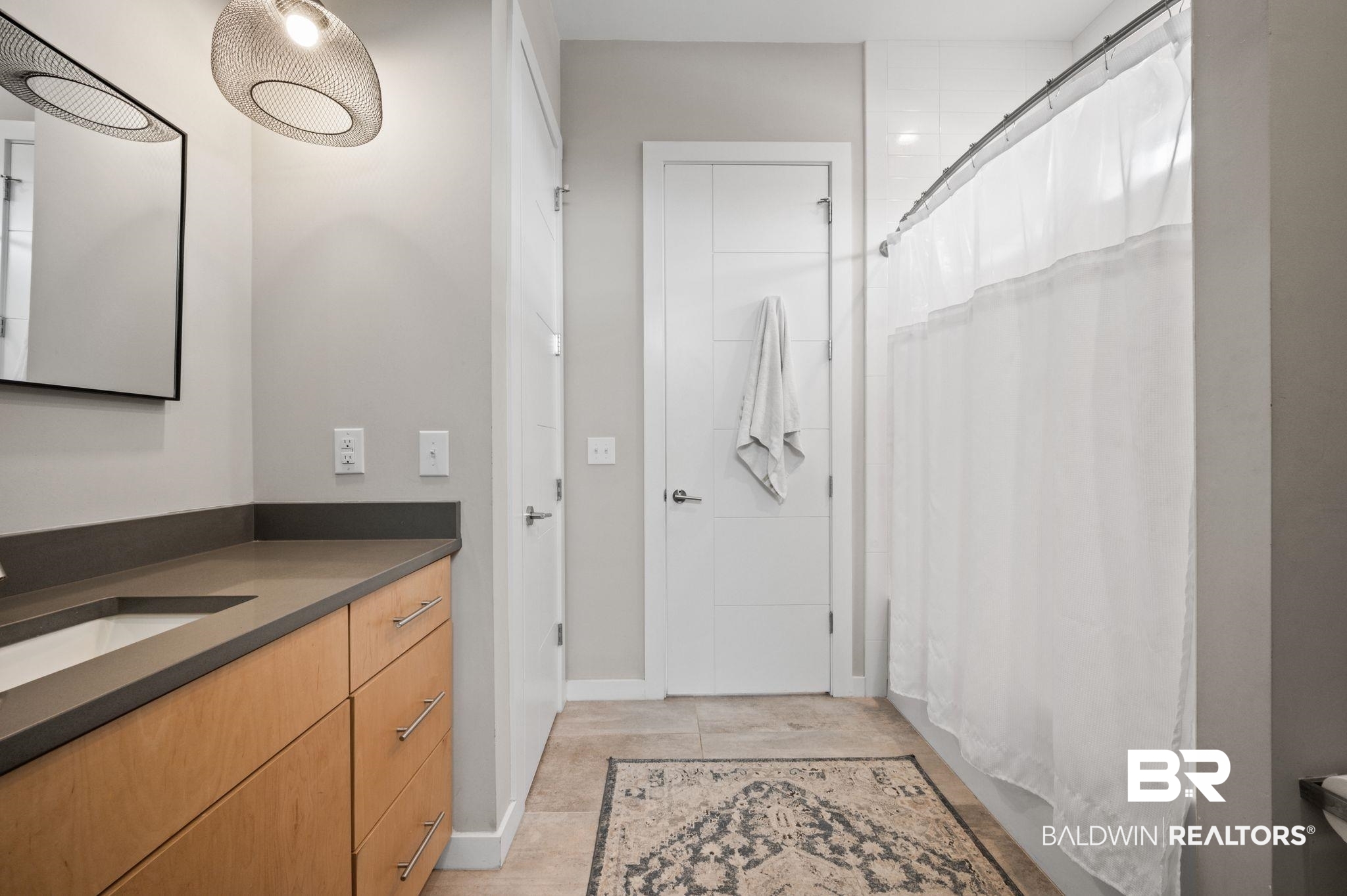 3840 Cotton Way Orange Beach, AL 36561 - Photo 29 of 75 Bathroom with curtained shower, tile patterned flooring, and vanity