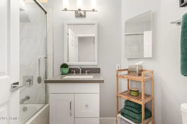 a bathroom with a sink a toilet and bathtub