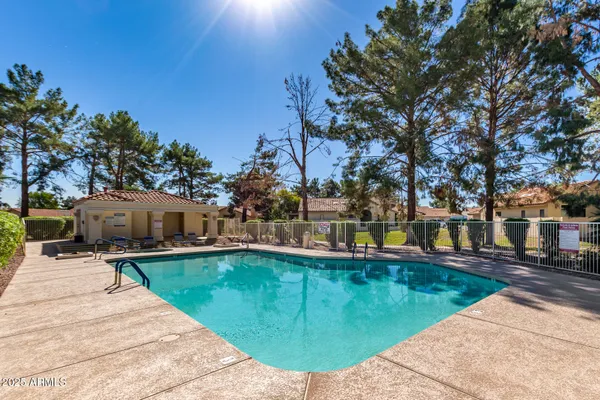 a swimming pool with outdoor seating and yard