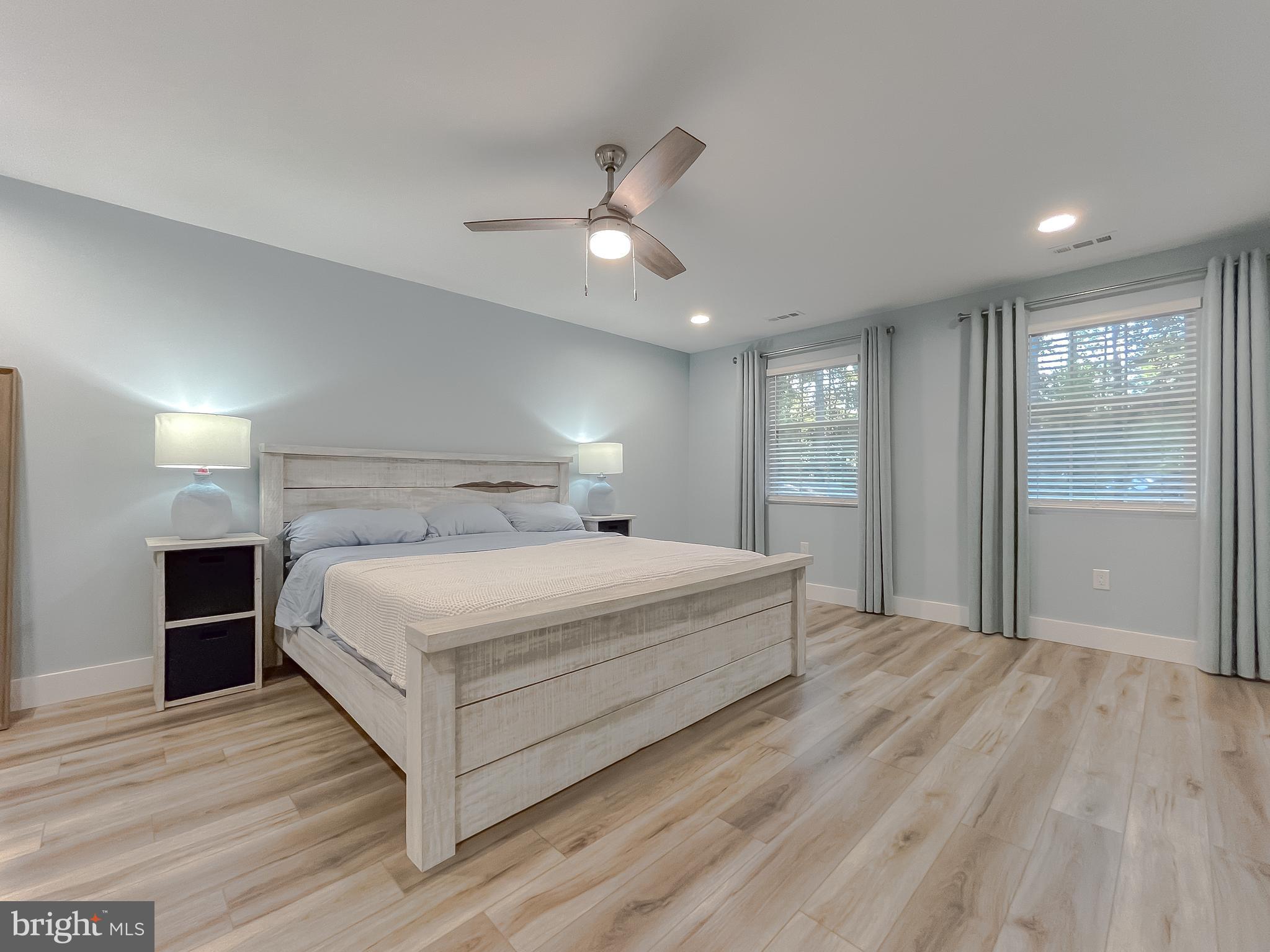 13630 Dowell Road Solomons, MD 20657 - Photo 51 of 121 a bedroom with a large bed chandelier and a window