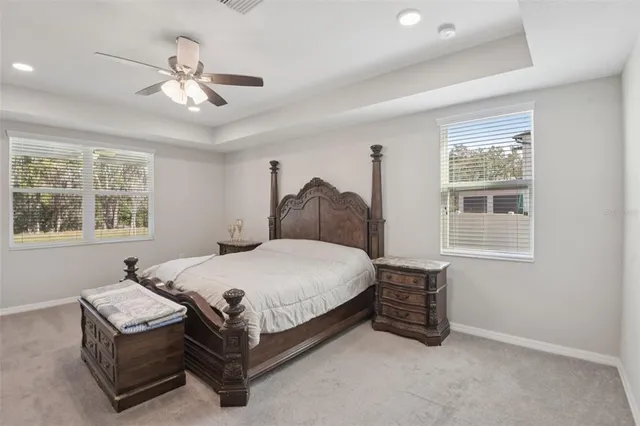 a bedroom with a bed a window and chandelier