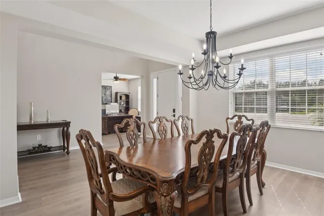 a view of a dining room with furniture wooden floor and chandelier